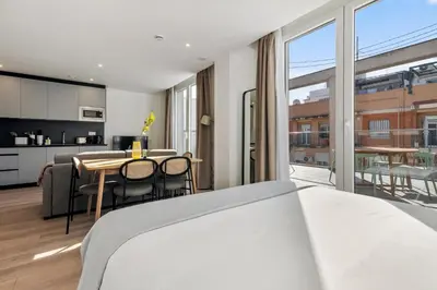 a bedroom with a bed and a table with chairs at Limehome Valencia Carrer del Pare Palau i Quer in Valencia