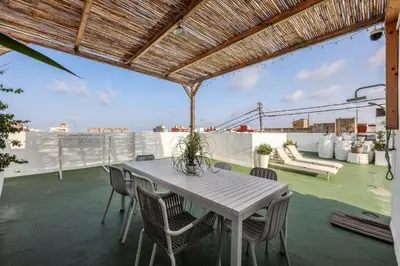 a table and chairs on the roof of a building at Amazinn Valencia Cabanyal 2C in Valencia