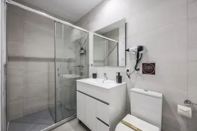 a bathroom with a shower and a sink and a toilet at AmazINN Valencia Cabanyal 3B in Valencia