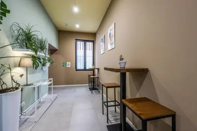 a room with a bar and some plants on the wall at AmazINN Valencia Cabanyal 3B in Valencia