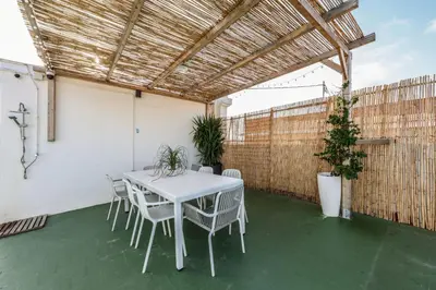 a white table and chairs on a patio at Amazinn Valencia Cabañal 3A in Valencia