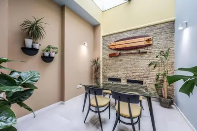a room with a brick wall and a table and chairs at Amazinn Valencia Cabañal 3A in Valencia