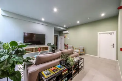 a living room with a couch and a flat screen tv at Amazinn Valencia Cabañal 3A in Valencia