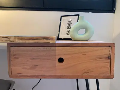 a wooden dresser with a vase on top of it at La Reina Beach rooms in Valencia