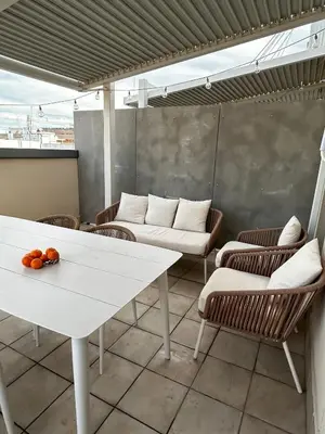 a white table and chairs on a balcony at Demetrio By Alma Suites in Valencia