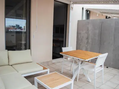 a living room with a table and a couch at Demetrio By Alma Suites in Valencia