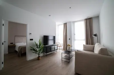 a living room with a couch and a bed at Demetrio By Alma Suites in Valencia