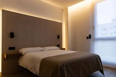 a bedroom with a large bed and a window at Demetrio By Alma Suites in Valencia