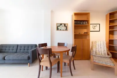 a living room with a table and chairs and a couch at Global Vacacional, Apartamento de 3 dormitorios y terraza en la playa de Canet in Canet de Berenguer