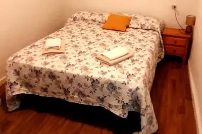 a bedroom with a bed with a table with towels on it at Casa rural para 8 huéspedes en plena naturaleza in Gestalgar