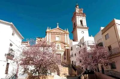 a tall building with a clock tower in a city at Casa rural para 8 huéspedes en plena naturaleza in Gestalgar
