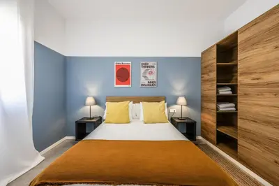a bedroom with a large bed with two night stands at AmazINN Valencia Cabanyal 3D in Valencia