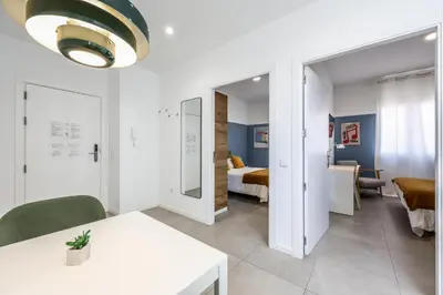 a living room with a room with a bed and a table at AmazINN Valencia Cabanyal 3D in Valencia