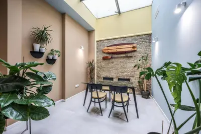 a dining room with plants and a brick wall at AmazINN Valencia Cabanyal 3D in Valencia