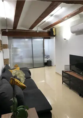 a living room with a couch and a flat screen tv at Estudio Pau @VALENCIAYOLE in Valencia