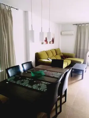 a living room with a couch and a table at Chulillagreenhouse in Chulilla