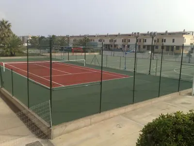 a tennis court with two tennis courts at Modern Penthouse-duplex Facing The Sea in La Torre