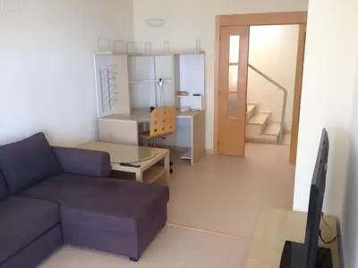 a living room with a couch and a table at Modern Penthouse-duplex Facing The Sea in La Torre