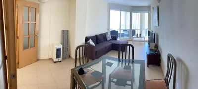 a living room with a couch and a glass table at Modern Penthouse-duplex Facing The Sea in La Torre