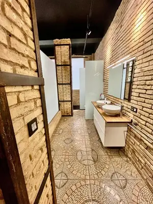 a bathroom with a sink and a brick wall at IY Loft 4 - Open Plan Garage Style - Up to 4 people in Valencia