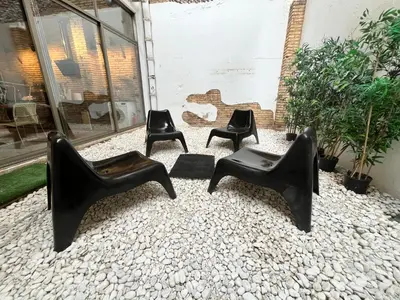 a group of black chairs sitting on a gravel ground at IY Loft 4 - Open Plan Garage Style - Up to 4 people in Valencia