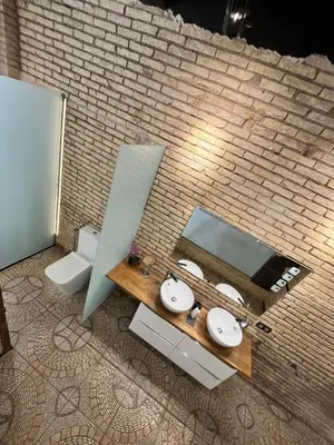 a bathroom with two sinks and a brick wall at IY Loft 4 - Open Plan Garage Style - Up to 4 people in Valencia