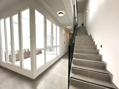 a staircase in a building with large windows at Almar 52 Suites in Valencia