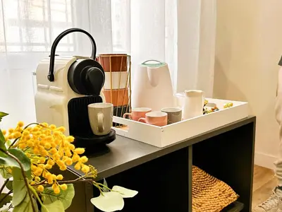 a kitchen counter with a coffee maker and cups on it at apartamento muy próximo a Valencia in Burjasot