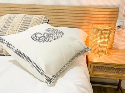 a bed with a pillow with a heart on it at apartamento muy próximo a Valencia in Burjasot