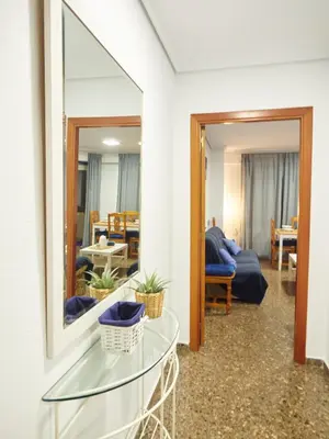 a living room with a glass table and a mirror at COSTA AZUL in Puerto de Sagunto