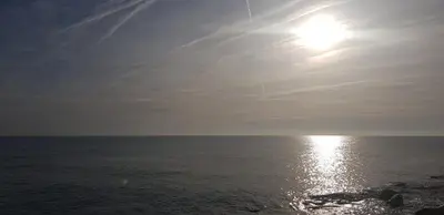 a view of the ocean with the sun in the sky at COSTA AZUL in Puerto de Sagunto