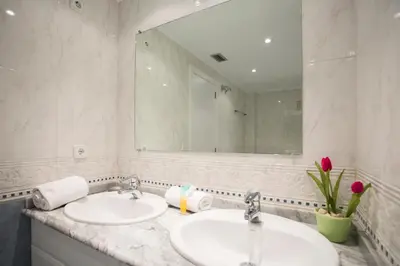 a bathroom with two sinks and a large mirror at SingularStays Alameda II in Valencia