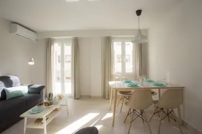 a living room with a table and a dining room at SingularStays Calderon in Valencia