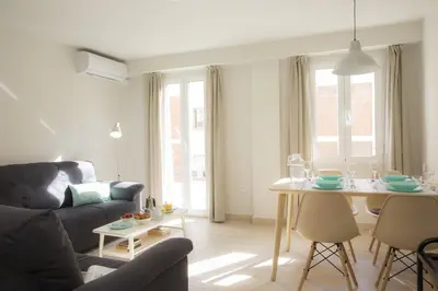 a living room with a couch and a dining room table at SingularStays Calderon in Valencia