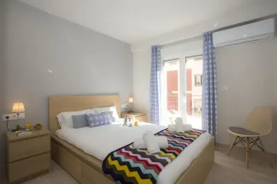 a bedroom with a large bed and a window at SingularStays Calderon in Valencia