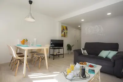 a living room with a couch and a table at SingularStays Calderon in Valencia
