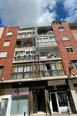 a tall brick building with a fire escape at SingularStays Guillem Sorolla in Valencia
