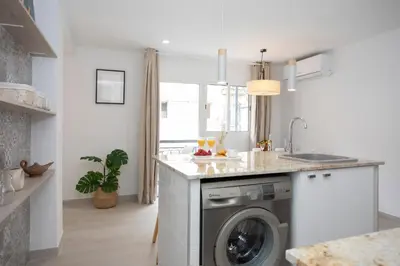 a kitchen with a washer and dryer at SingularStays Guillem Sorolla in Valencia
