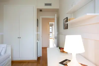 a living room with a lamp on a table at SingularStays Palacio de Congresos in Valencia