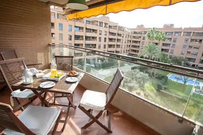 a balcony with a table and chairs and a large window at SingularStays Palacio de Congresos in Valencia