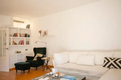 a living room with a white couch and a chair at SingularStays Palacio de Congresos in Valencia