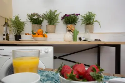 a table with a bowl of fruit and a glass of orange juice at SingularStays Quevedo II in Valencia