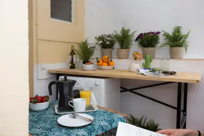 a table with a coffee maker and fruits and plants at SingularStays Quevedo II in Valencia
