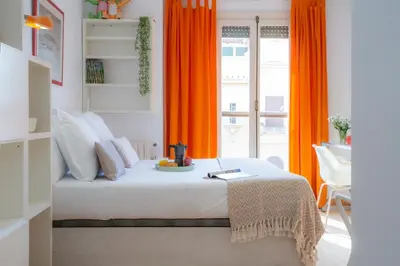 a desk and a chair in a room with a window at SingularStays Reina II in Valencia