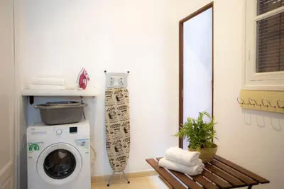 a laundry room with a washing machine and a mirror at SingularStays Salvador IV in Valencia