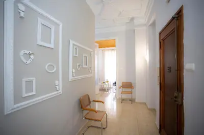 a hallway with white walls and chairs in a room at SingularStays Salvador IV in Valencia
