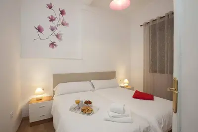 a bedroom with a bed with a tray of food on it at SingularStays SEU V in Valencia