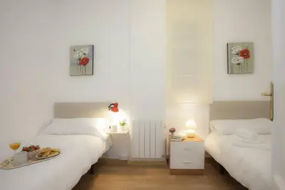 two beds in a small room with white walls at SingularStays SEU V in Valencia