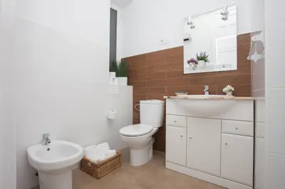 a white bathroom with a sink and a toilet at SingularStays SEU V in Valencia