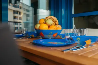 a table with a bowl of fruit on a table at RESORT BEACH VALENCIA in Valencia
